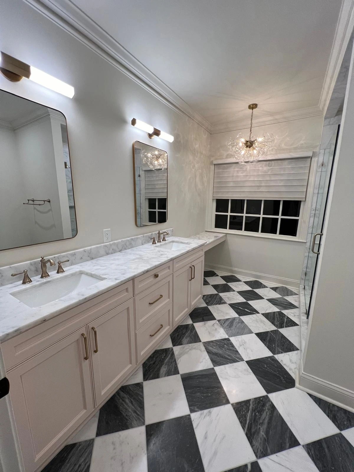 Double vanity with quartz counters over a black-and-white checkered tile floor