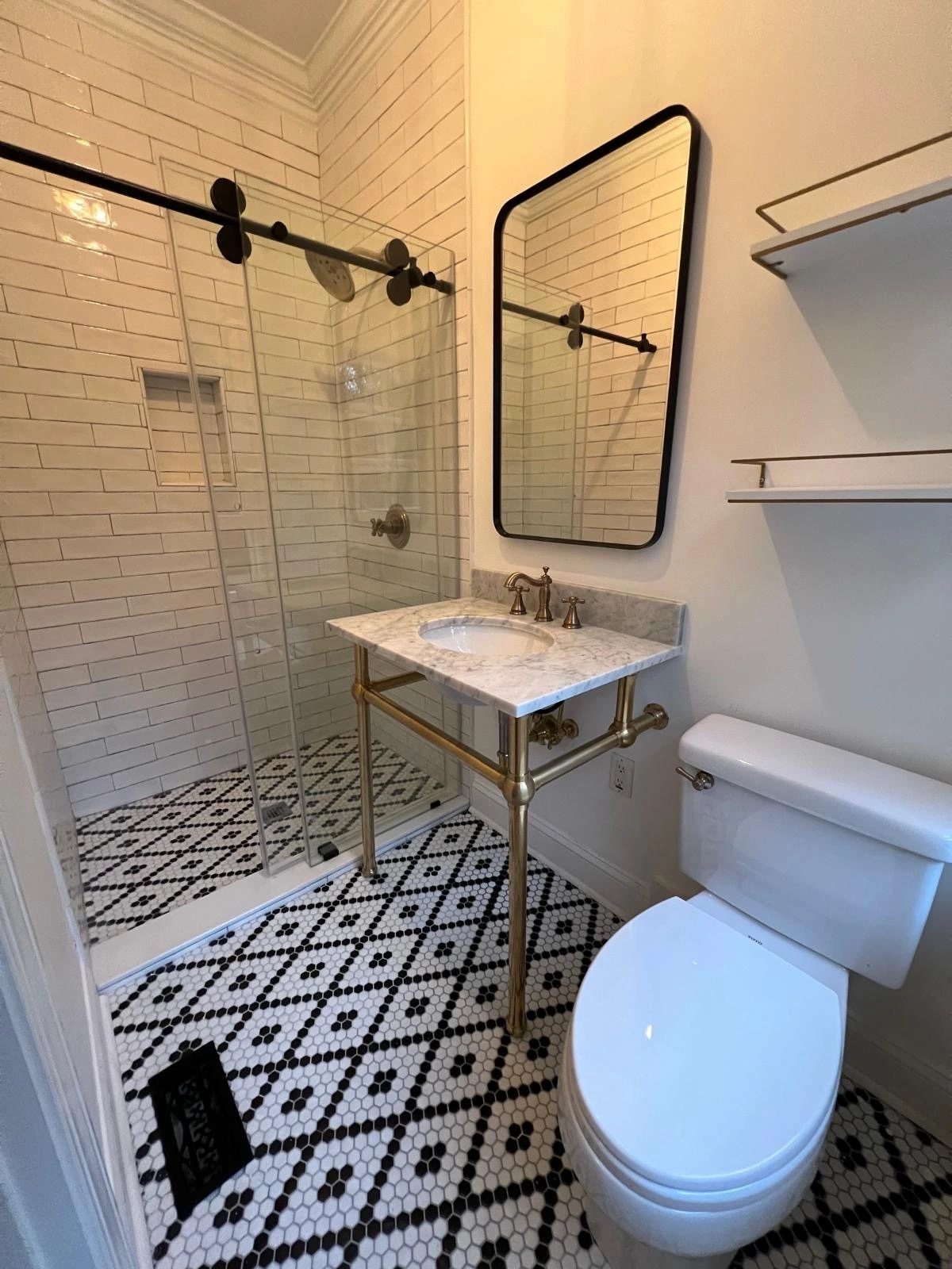 Bathroom with geometric black-and-white floor tile and pedestal sink — Miami, FL