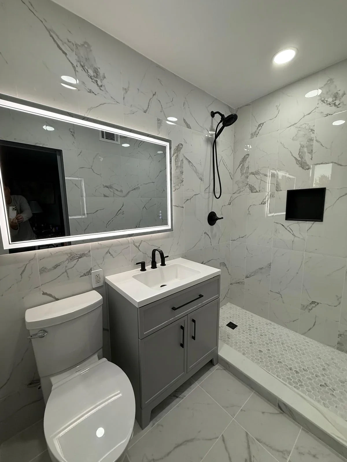 Modern bathroom remodel with walk-in shower and floating vanity