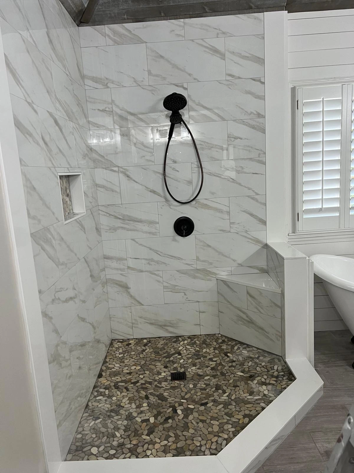 Marble walk-in shower with pebble stone shower pan