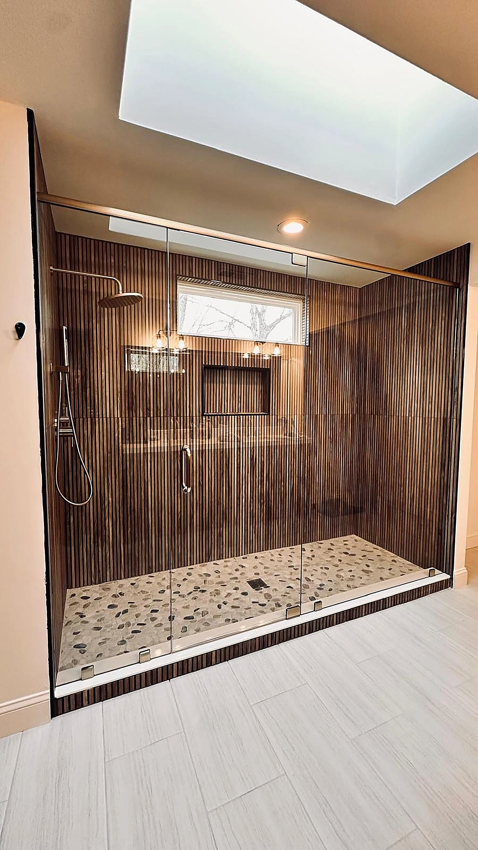 Wood-look ribbed tile shower with skylight and pebble stone shower pan — Weston, FL