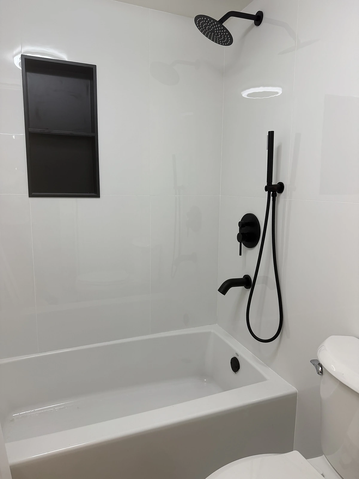 White tub-shower combination with matte black fixtures