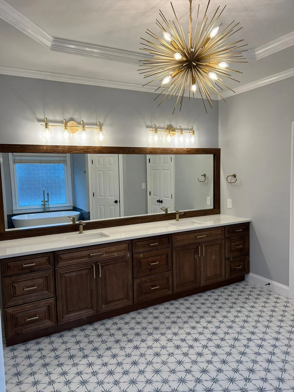 Bathroom vanity with sputnik-style light fixture and marble counter