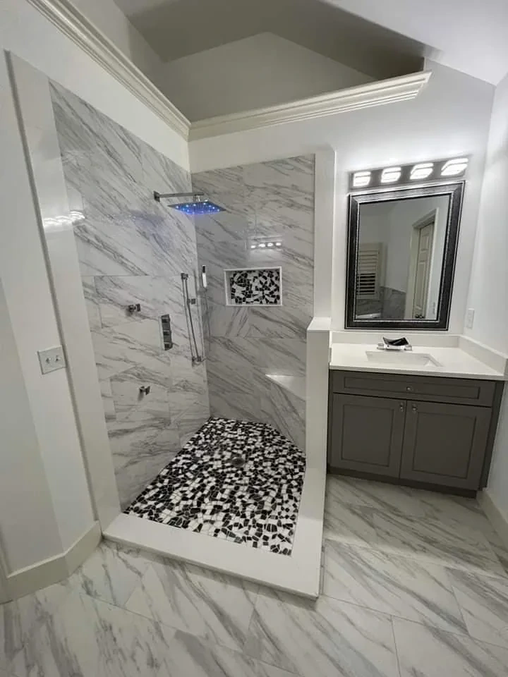 Marble shower with rainfall head, mosaic pan and floating vanity