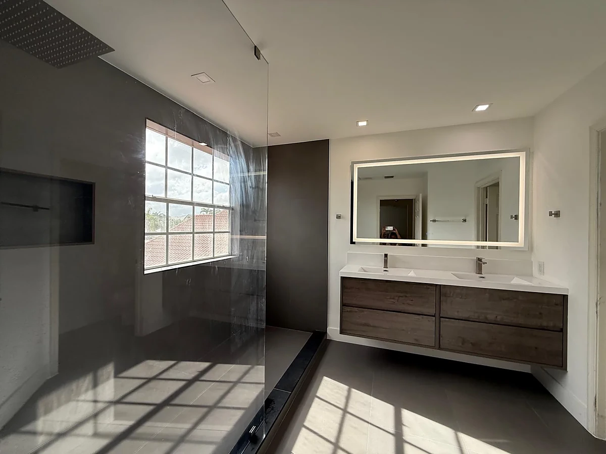 Bathroom with double floating vanity and glass block window