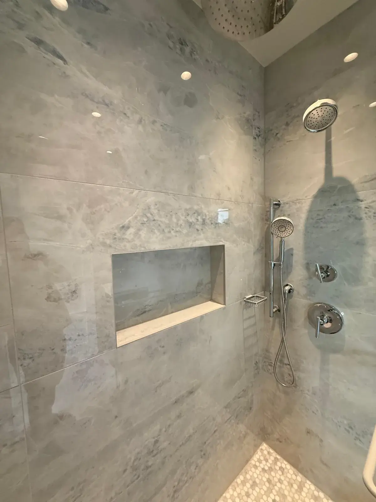 Custom walk-in shower with recessed niche and mosaic tile accent in bathroom remodel Deerfield Beach FL