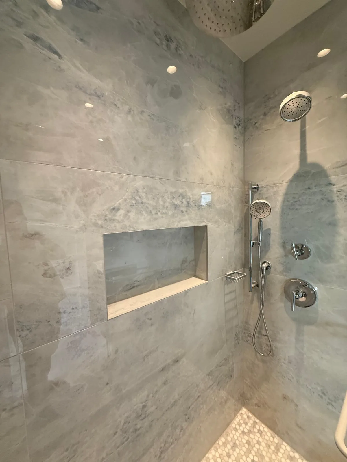 Custom marble walk-in shower remodel with frameless glass enclosure in Deerfield Beach FL