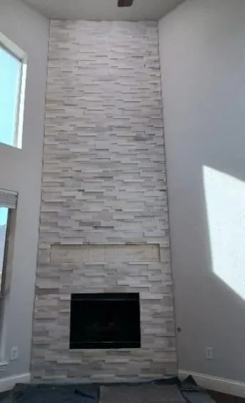 Custom stone veneer fireplace and decorative accent wall