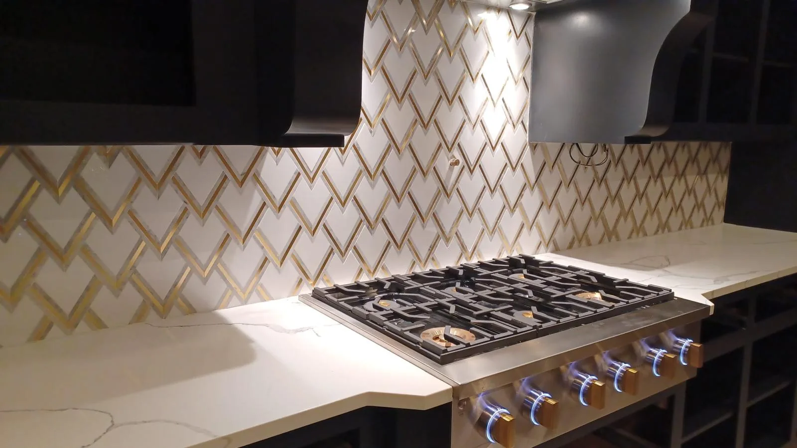 Premium gold chevron pattern backsplash with white quartz countertop in custom kitchen remodel Fort Lauderdale FL